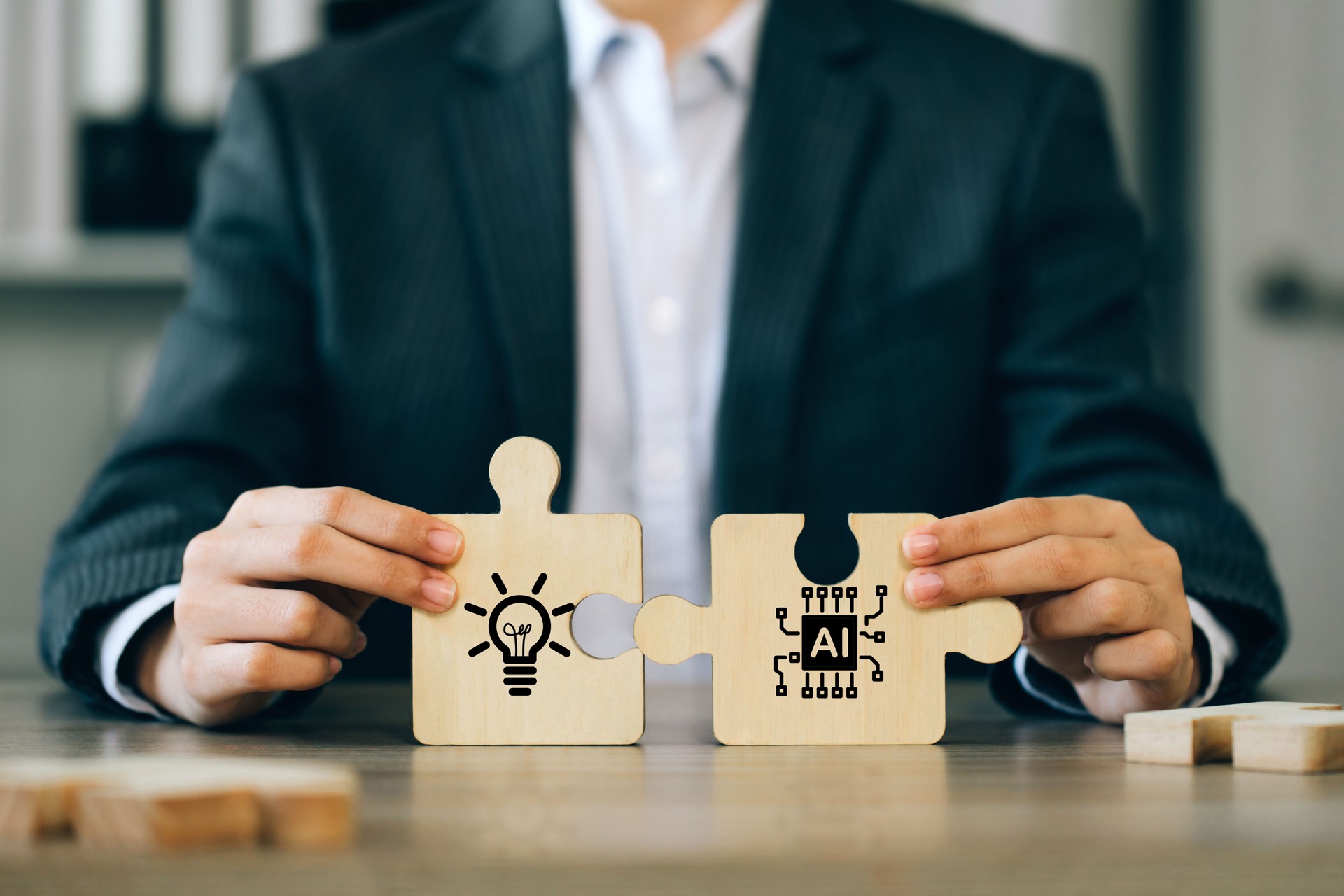 A businessman holding a jigsaw puzzle with a light bulb and AI connected. Using AI to generate business ideas. for new products or services, creative ideas, or content. AI adoption for business.